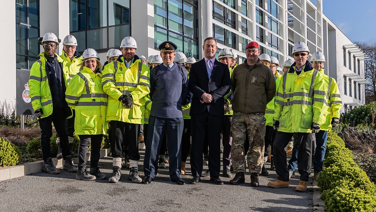 Members of the armed forces with the Skanska construction team in front of the newly built Royal College of Policing, Logistics and Administration